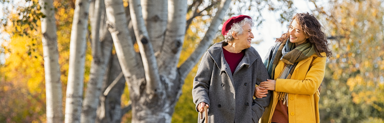 A young woman with an elderly woman in the park.